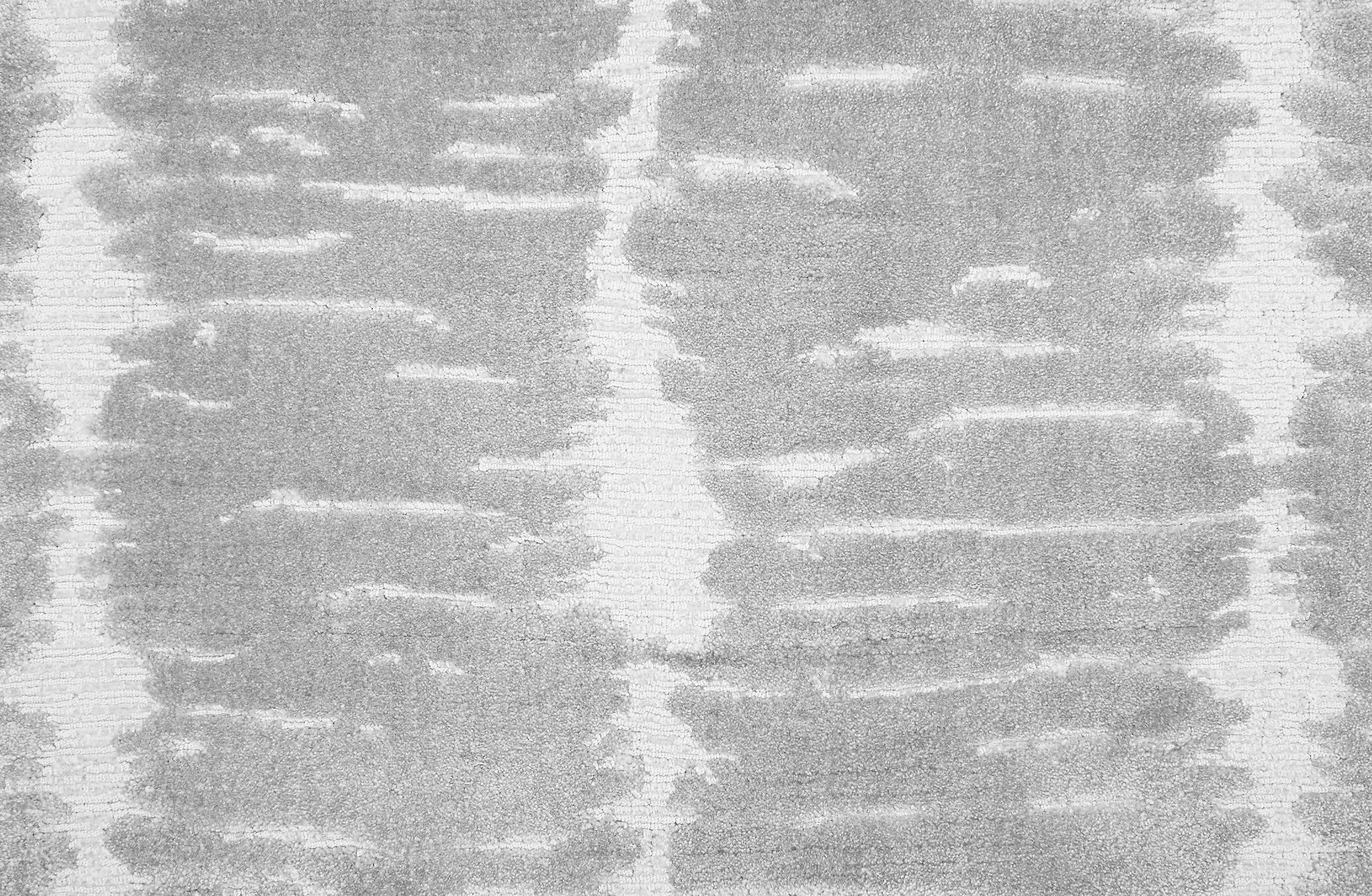 Broadloom carpet in a dimensional abstract painterly pattern in light grey on a white field.