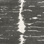 Broadloom carpet in a dimensional abstract painterly pattern in grey on a cream field.