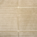 Textural performance broadloom carpet in grid design in tan.