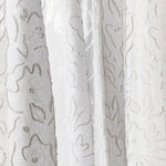 Draped sheer fabric in a hand drawn floral pattern in ivory.