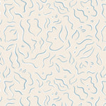 Detail of wallpaper in a painterly botanical print in light blue and white on a tan field.