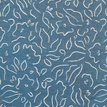 Detail of fabric in a minimalist floral print in cream on a navy field.