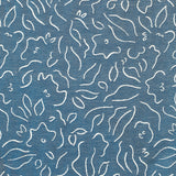 Detail of fabric in a minimalist floral print in cream on a navy field.