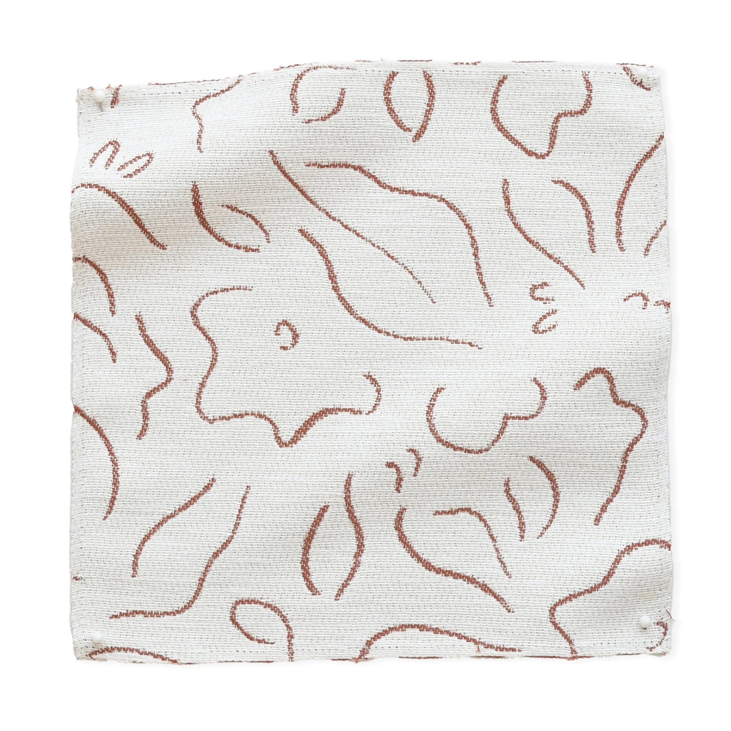 Fabric swatch with brown floral pattern on white background