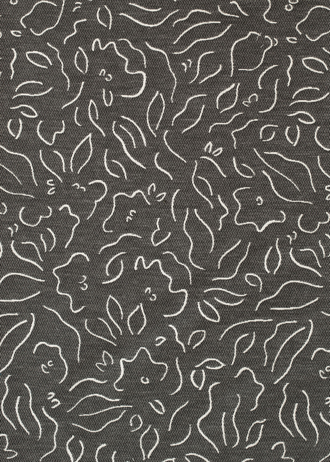 Detail of fabric in a minimalist floral print in cream on a charcoal field.