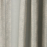 Draped printed fabric in a scrolling floral stripe pattern in cream on a light blue-gray field.