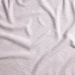 Close up of gently draped woven Indoor-Outdoor fabric with basketweave texture in white.