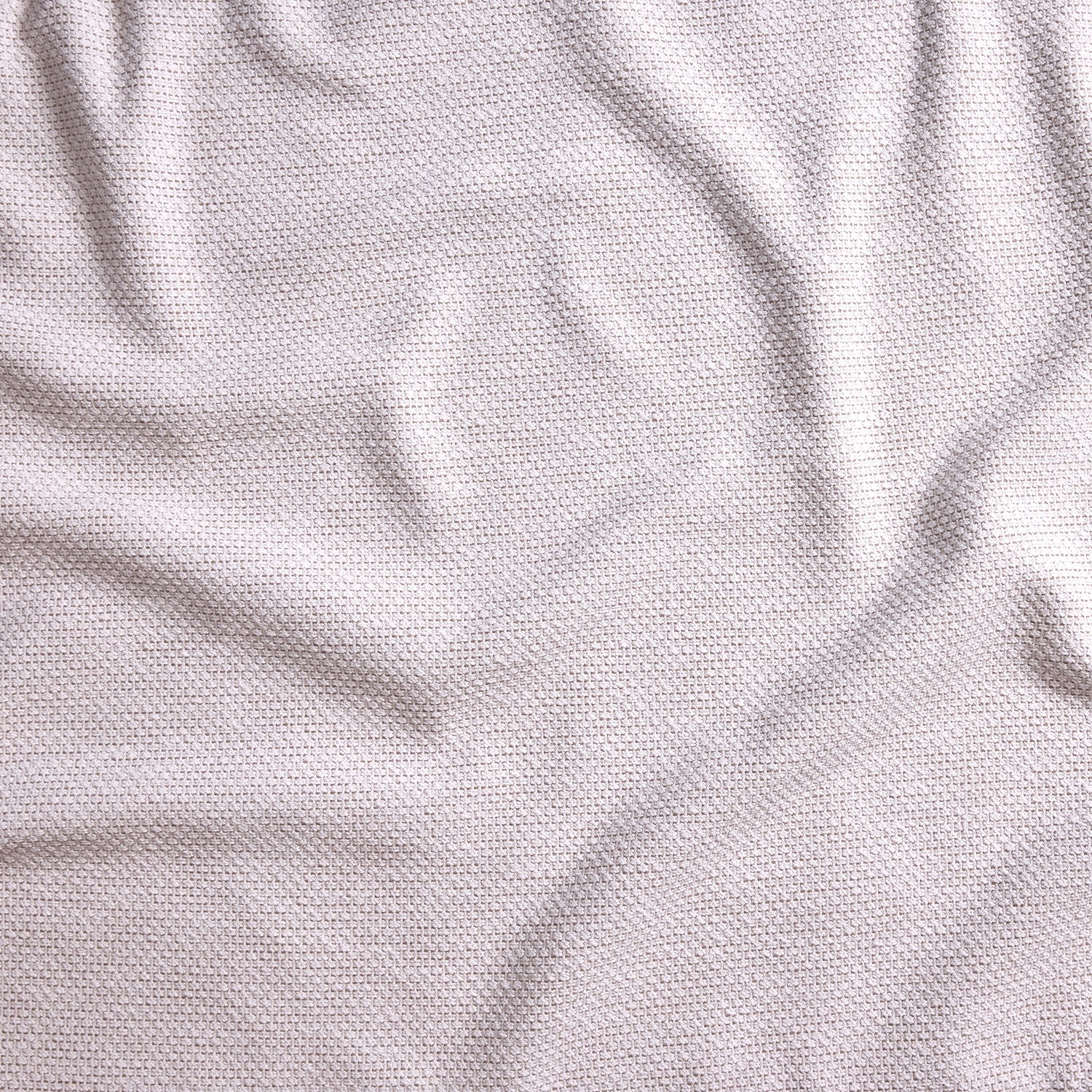 Close up of gently draped woven Indoor-Outdoor fabric with basketweave texture in white.