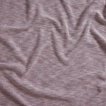 Close up of gently draped woven Indoor-Outdoor fabric with basketweave texture in white and navy blue.