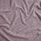 Close up of gently draped woven Indoor-Outdoor fabric with basketweave texture in white and navy blue.