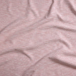 Close up of gently draped woven Indoor-Outdoor fabric with basketweave texture in white and coral red.
