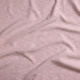 Close up of gently draped woven Indoor-Outdoor fabric with basketweave texture in white and coral red.