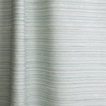 Draped fabric in a textural striped pattern in shades of aqua blue.