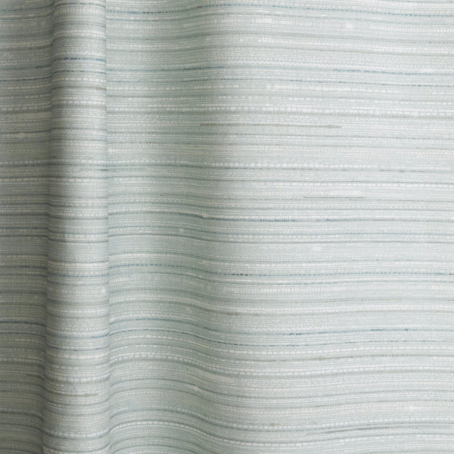 Draped fabric in a textural striped pattern in shades of aqua blue.
