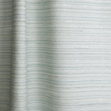 Draped fabric in a textural striped pattern in shades of aqua blue.