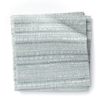 Stacked swatches of fabric in a textural striped pattern in shades of aqua blue.