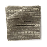 Stacks of fabric swatches textural striped pattern in shades of muted olive green on a white background.