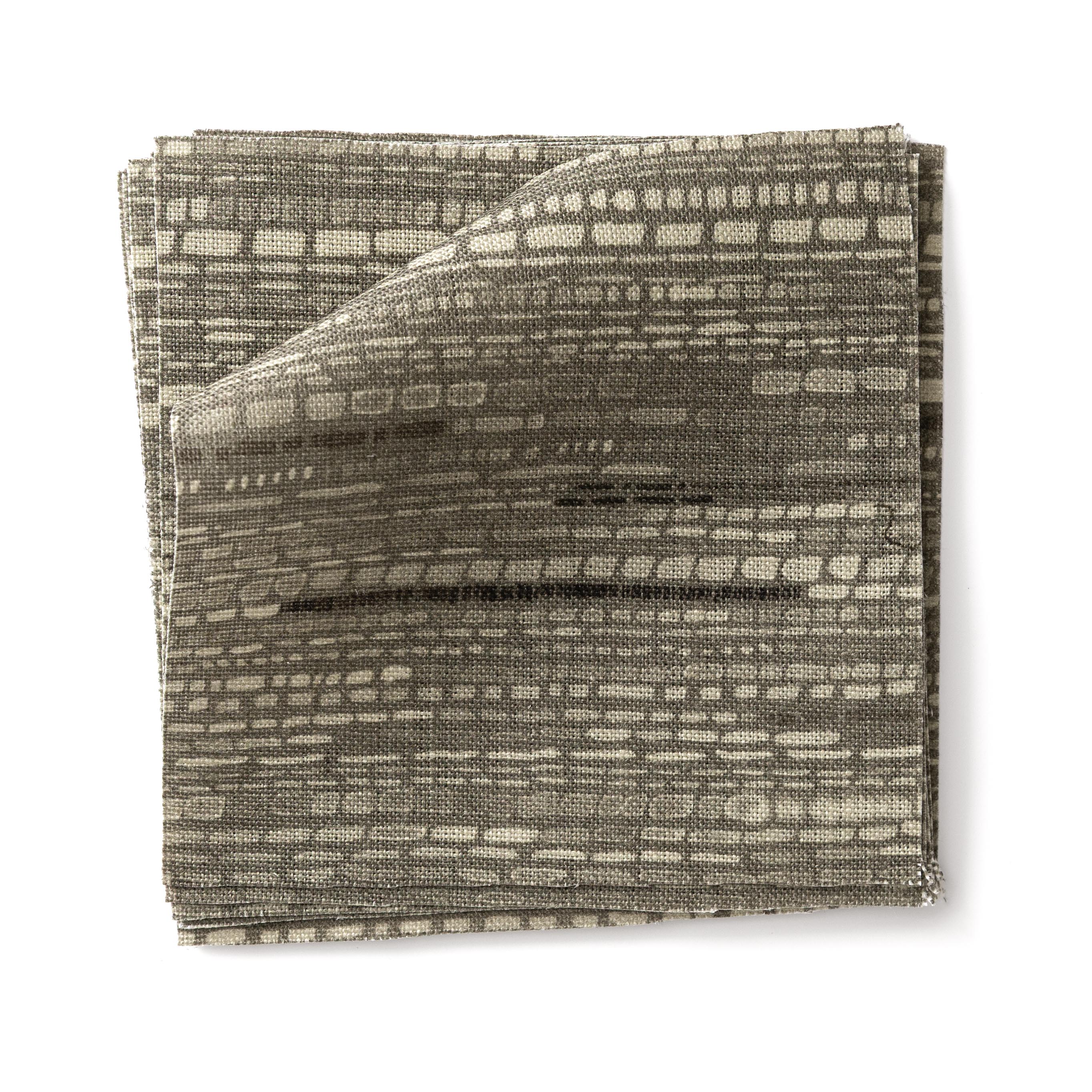 Stacks of fabric swatches textural striped pattern in shades of muted olive green on a white background.