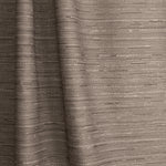 Gently draped fabric in a textural striped pattern in shades of charcoal grey on on a white background.