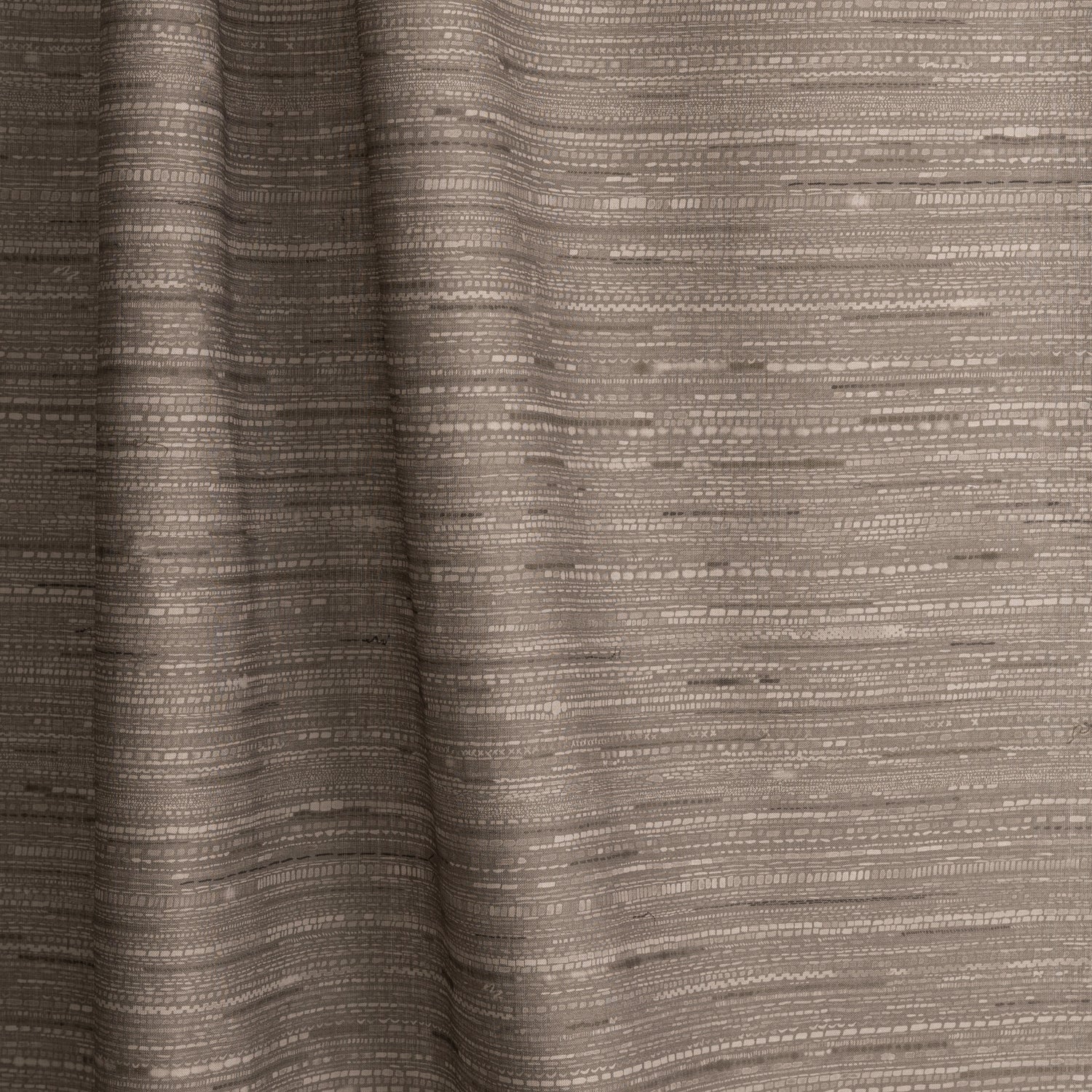 Gently draped fabric in a textural striped pattern in shades of charcoal grey on on a white background.