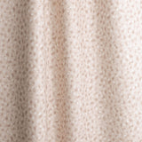 Gently draped fabric in a painterly animal print in pastel pink with white accents. 