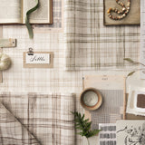 Collection of fabric swatches and decorative items on a neutral background