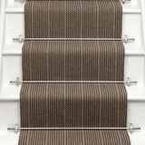 Striped flatweave runner in brown and red on white staircase