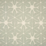 Detail of fabric in a shibori grid print in white on a gray field.