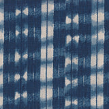 Detail of fabric in a textural shibori print in shades of navy on a greige field.