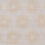 Detail of fabric in a repeating circular geometric print in yellow on a greige field.