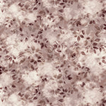 Detail of fabric in a painterly leaf print in shades of wine purple and mauve with a mottled white overlay.