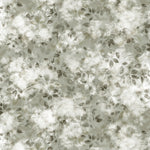 Detail of fabric in a painterly leaf print in shades of grey-green with a mottled white overlay.