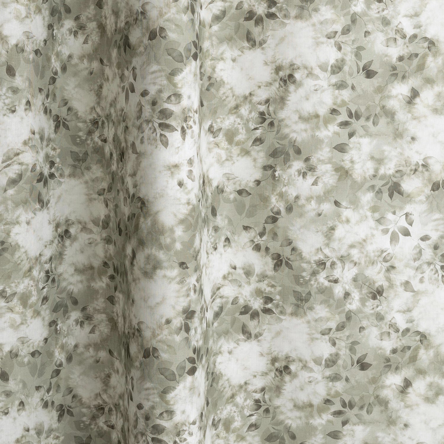 Gently draped fabric in a painterly leaf print in shades of grey-green with a mottled white overlay.
