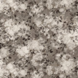 Detail of wallpaper in a painterly leaf print in shades of warm charcoal grey with a mottled white overlay.