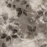 Close up detail wallpaper in a painterly leaf print in shades of warm charcoal grey with a mottled white overlay.