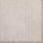 Close-up of a textured beige rug with a subtle pattern