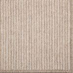 Close-up of a textured beige carpet with a subtle pattern