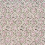 Detail of fabric in a floral damask print in shades of pink and green on a cream field.