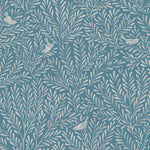 Detail of fabric in a playful bird and leaf print in cream on a blue field.