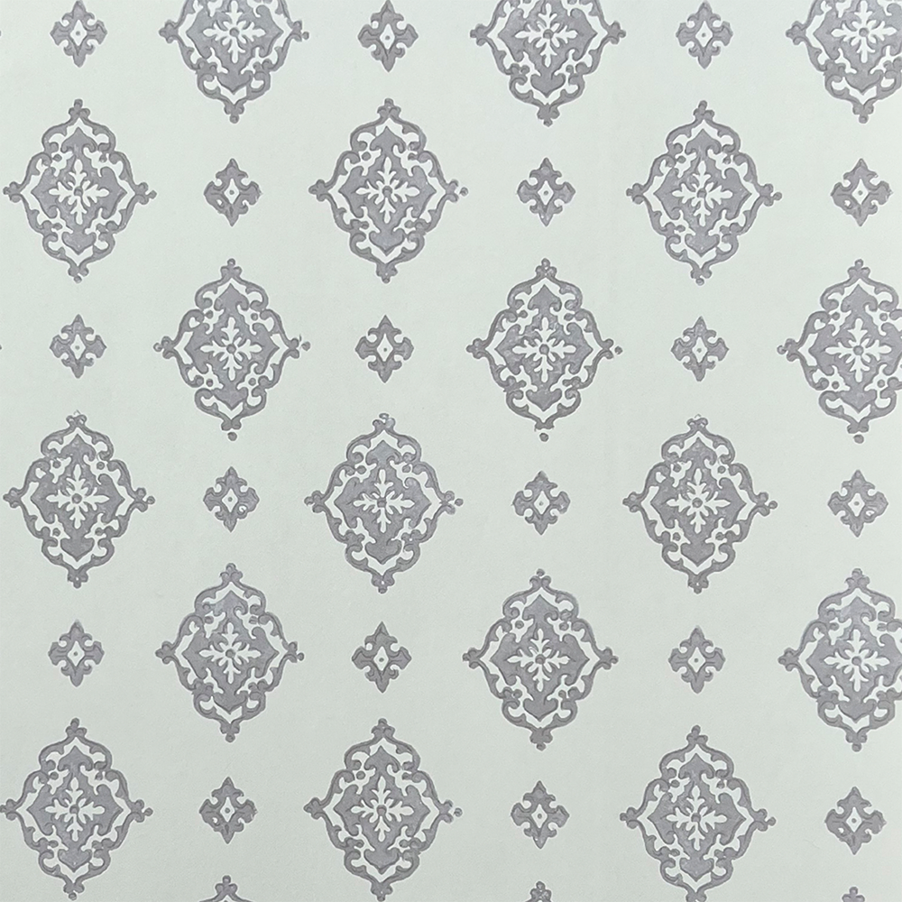 Detail of fabric in a floral damask print in gray on a light blue field.