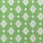 Detail of fabric in a floral damask print in white on a green field.