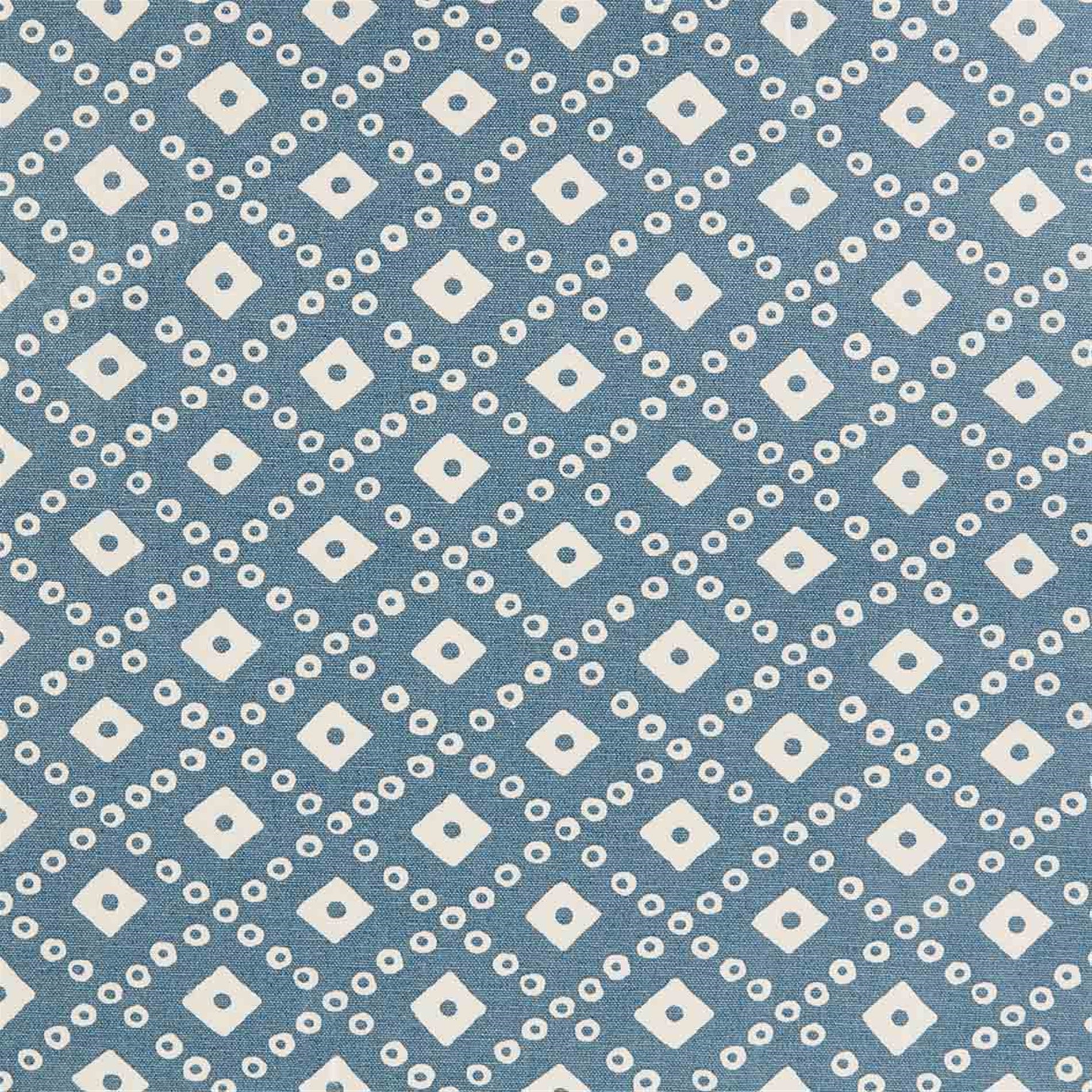 Detail of fabric in a geometric lattice print in white on a blue field.