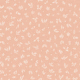 Detail of fabric in a minimal repeating leaf print in cream on a light pink field.