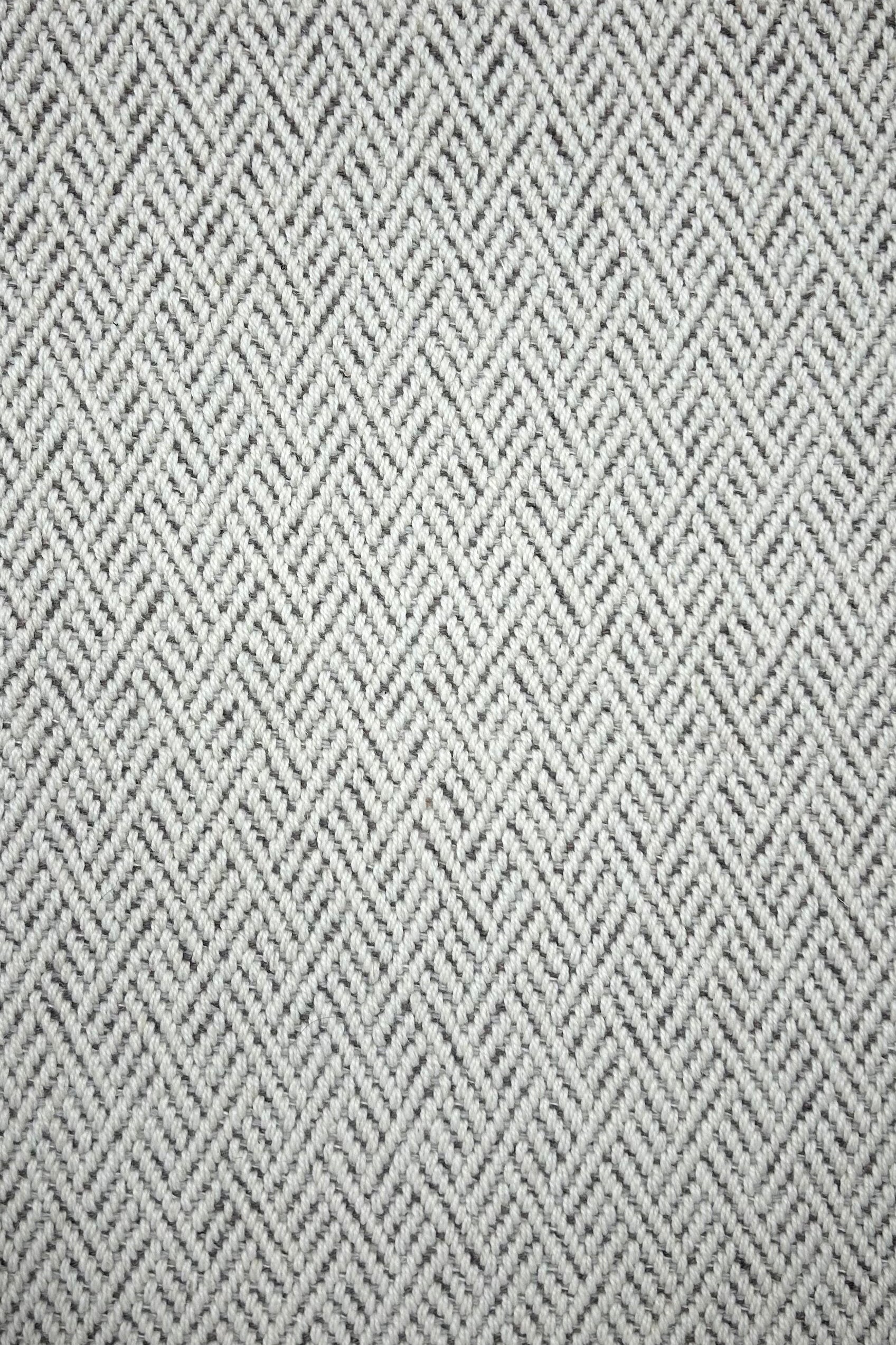Broadloom carpet in a linear geometric design in grey and white. 