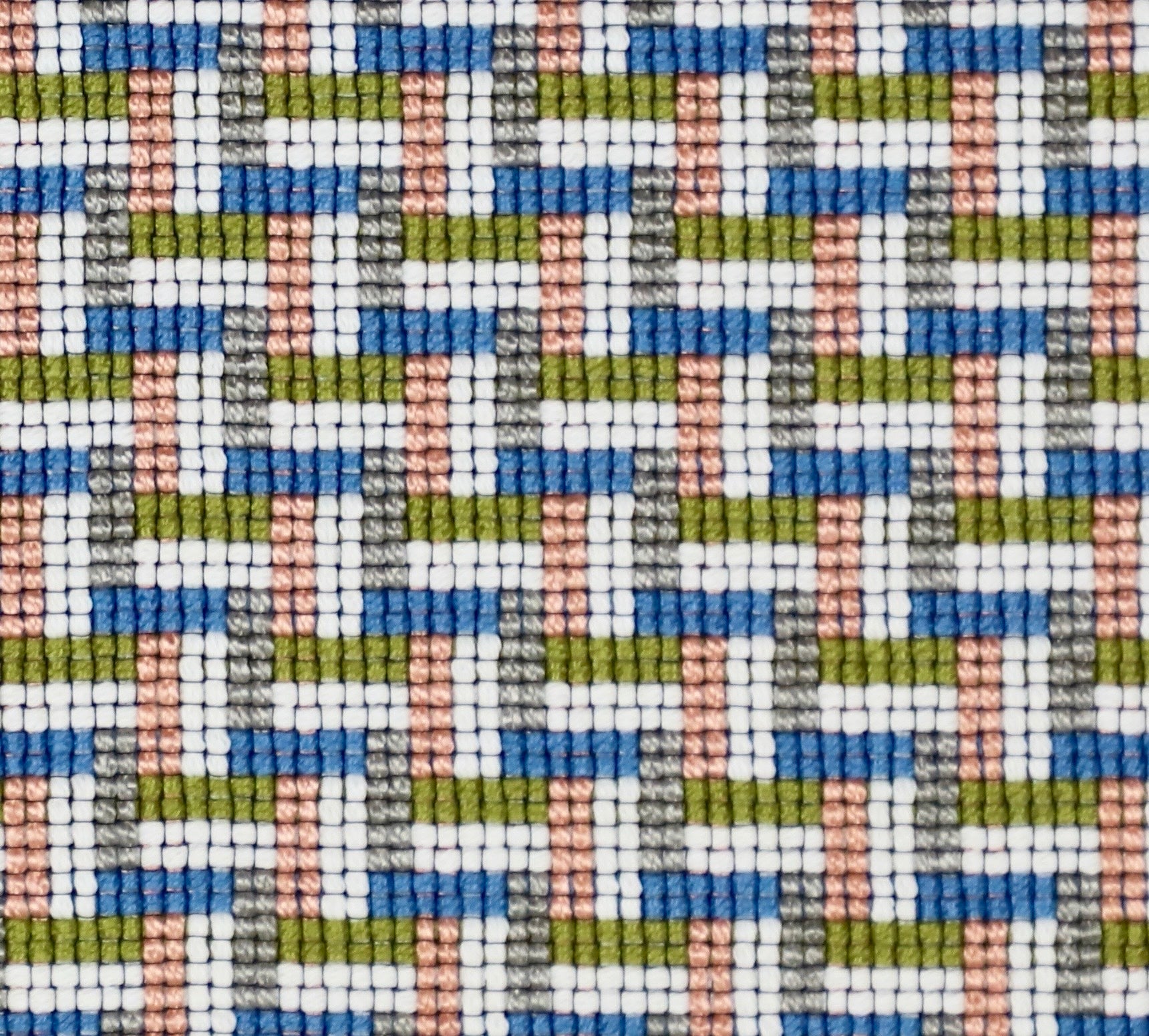 Detail of a woven stair step pattern in peach, chambray, white and lime green.