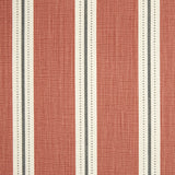 Detail of fabric in a repeating stripe print in white and gray on a burnt orange field.