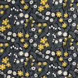 Detail of fabric in a small-scale floral print in white, gray and yellow on a dark gray field.