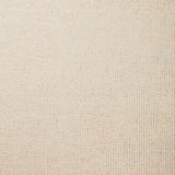 Detail of wallpaper in a paint splatter print in gold on a cream field.