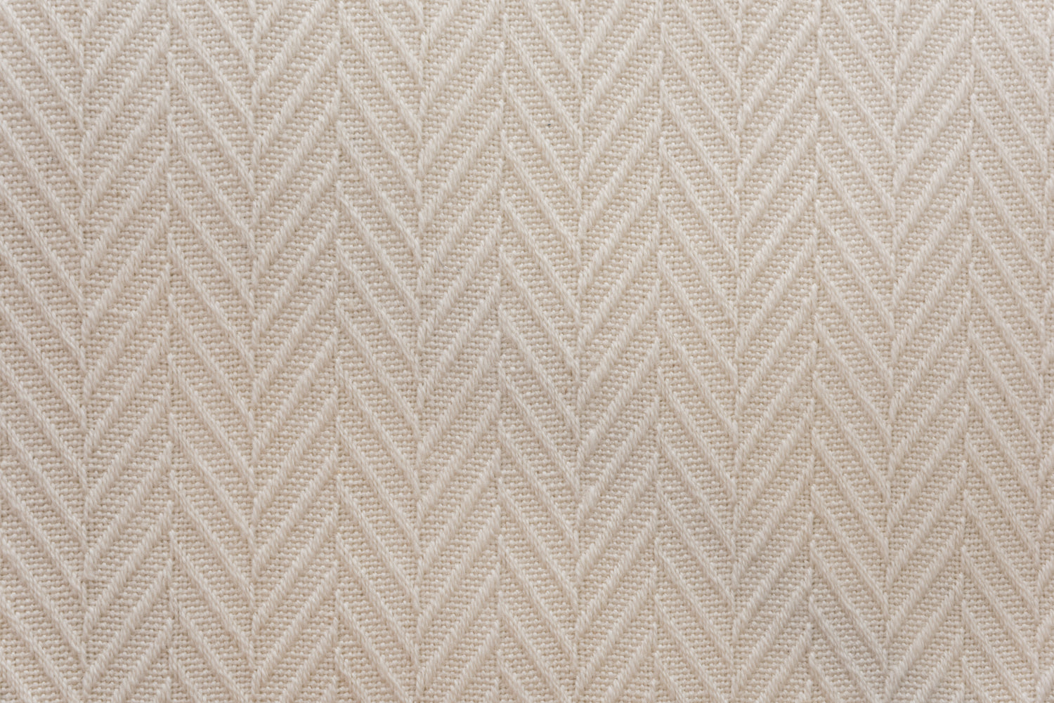 Broadloom carpet in a dimensional herringbone pattern in ivory. 