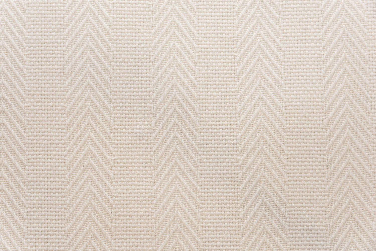 Broadloom carpet in a herringbone stripe in cream. 